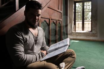 Humble Muslim Man Is Reading The Koran In The Mosque