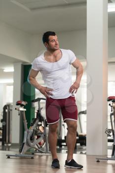 Portrait of a Young Physically Fit Man in White T-shirt Showing His Well Trained Body - Muscular Athletic Bodybuilder Fitness Model Posing After Exercises