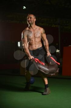 Handsome Man Performing Bag Exercise Indoors In Gym