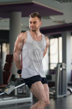 Portrait Of A Young Physically Fit Man In Undershirt Showing His Well Trained Body - Muscular Athletic Bodybuilder Fitness Model Posing After Exercises