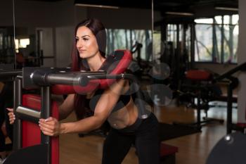 Attractive Woman Doing Leg With Machine In Gym - Leg Exercises