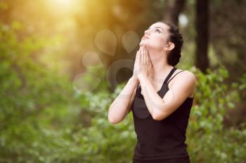 Young Woman Stretching Before Running In Wooded Forest Area - Training And Exercising For Trail Run Marathon Endurance - Fitness Healthy Lifestyle Concept