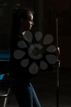 Young Woman Looking Confused At Billiard Table - She Is Losing