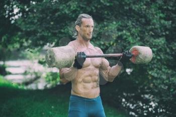 Muscular Adult Man Doing A Exercise For Biceps With Made Hand Barbell Outdoors Workout