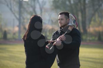 Young Couple Stretching Before Running In City Park Area - Training And Exercising For Trail Run Marathon Endurance - Fitness Healthy Lifestyle Concept Outdoor