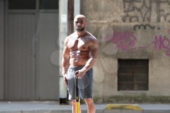 Athletic Man Resting - Workout At Gym With Hammer And Tractor Tire