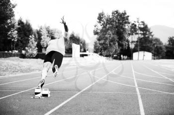 Fit and Confident Man in Starting Position Ready for Running