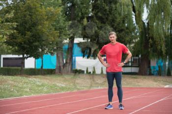 Young Runner Athlete Man Relax and Ready for Run at Athletics Race Track