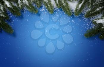 Merry Christmas holiday top circle snowy fir branch border on blue background for the seasonal tradition   