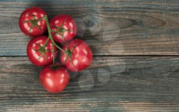Overhead of fresh tomatoes on faded blue rustic wood table 