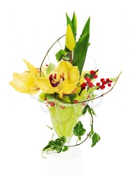 bouquet from orchids, tulips and ivy arrangement centerpiece in glass vase isolated on white background