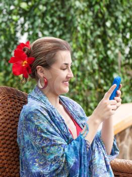 Portrait of smiling beautiful woman texting with her phone.