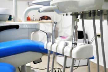 Close up shot inside a dental clinic showing the chair and part of the tools