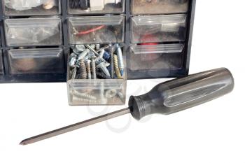 Screwdriver and screws in a tool cabinet isolated on white