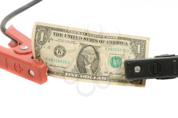 JUmper cables holding a dollar bill isolated on white