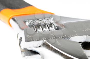 Macro shot of an adjustable wrench on white