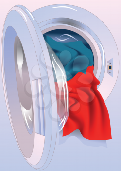 Opened washing machine door with colored clothes
