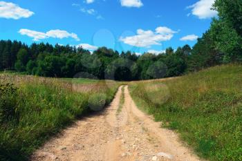 Beautiful summer landscape with sky, clouds and forest road