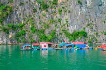 Floating fishing village and rock islands in Halong Bay, Vietnam, Southeast Asia. UNESCO World Heritage Site.