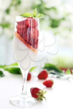 cream jelly with strawberries in a glass