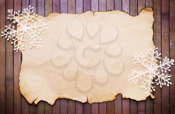 Old burnt empty paper  and decorative snowflakes