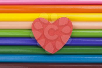 Heart on colored pencils.