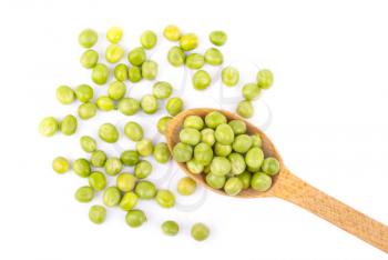 Green peas in a wooden spoon on a white background.