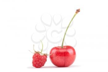 Raspberries and cherries on a white background.