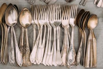 Set Of Retro, Old, Vintage Cutlery Spoons And Forks On Gray Background. Top View