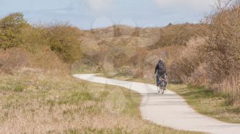 A cyclist is cycling on the dutch isle of Schiermonnikoog