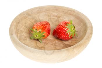 Two fresh strawberries in a wooden bowl
