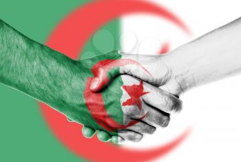 Man and woman shaking hands, wrapped in flag pattern, Algeria