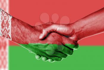 Man and woman shaking hands, wrapped in flag pattern, Belarus