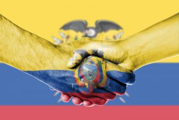 Man and woman shaking hands, wrapped in flag pattern, Ecuador