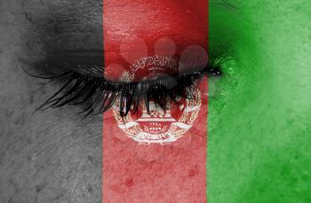 Crying woman, pain and grief concept, flag of Afghanistan