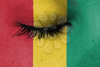 Crying woman, pain and grief concept, flag of Guinea