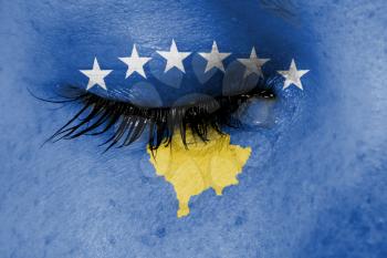 Crying woman, pain and grief concept, flag of Kosovo