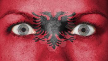 Close up of eyes. Painted face with flag of Albania
