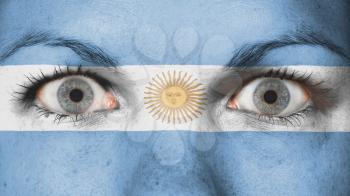 Close up of eyes. Painted face with flag of Argentina