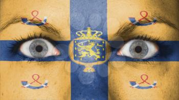 Close up of eyes. Painted face with flag of kingdom of the Netherlands