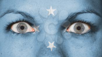 Close up of eyes. Painted face with flag of Micronesia
