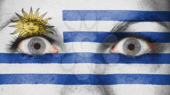 Close up of eyes. Painted face with flag of Uruguay