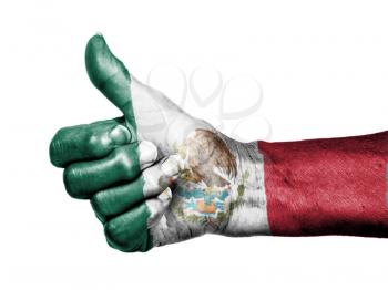 Old woman with arthritis giving the thumbs up sign, wrapped in flag pattern, Mexico
