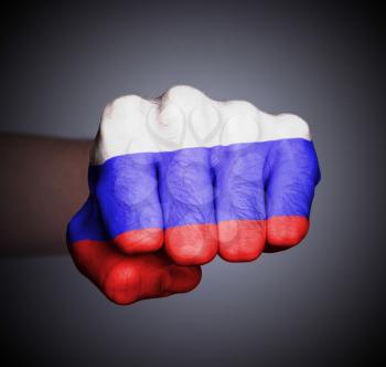 Front view of punching fist on gray background, flag of Russia