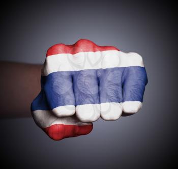 Front view of punching fist on gray background, flag of Thailand
