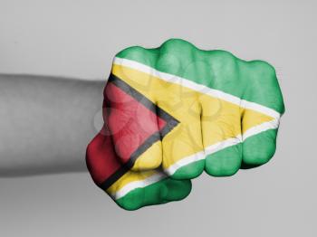 Fist of a man punching, flag of Guyana