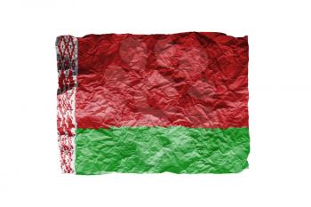 Close up of a curled paper on white background, print of the flag of Belarus