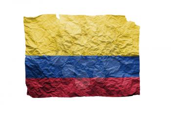 Close up of a curled paper on white background, print of the flag of Colombia