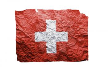 Close up of a curled paper on white background, print of the flag of Switzerland