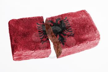 Rough broken brick, isolated on white background, flag of Albania